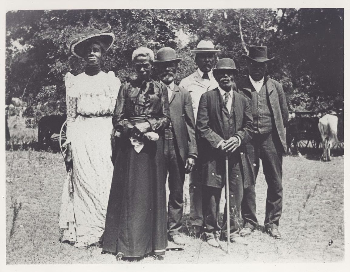 Black and white photo of Black Americans standing together at a celebration.