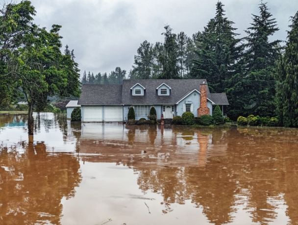 Photo of house exterior with flooded yard