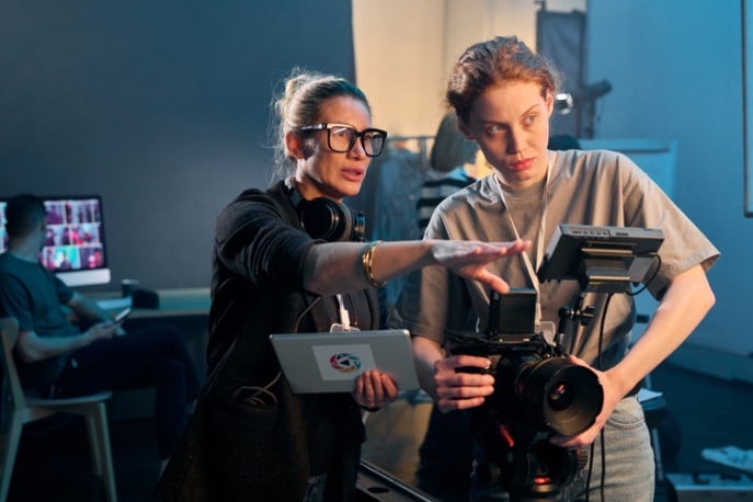 Woman director giving instruction to woman camera operator